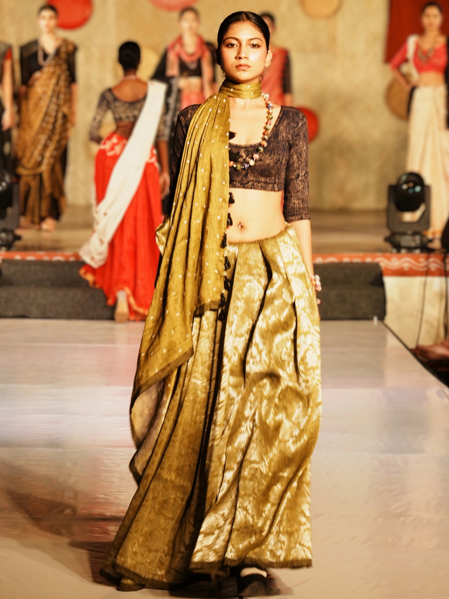 Model wearing Soulweaves's Pallavi Saree collection on a fashion show runway.