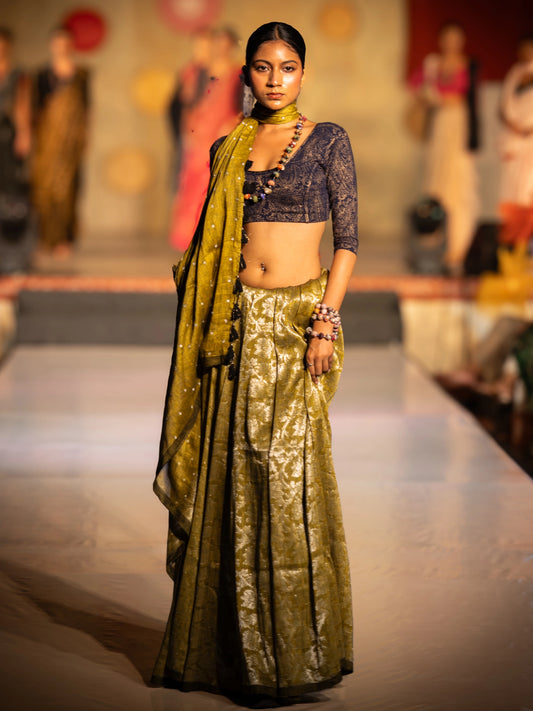 Model wearing a traditional outfit of Soulweaves's Pallavi Saree collection on a fashion show runway